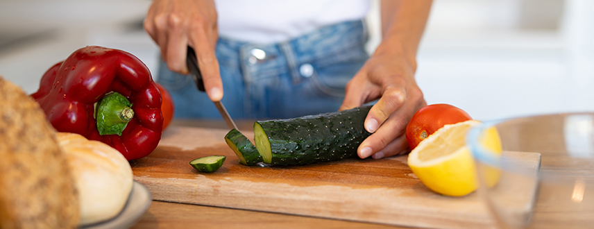 Woman preparing healthy meal in kitchen showing digestive enzyme support for everyday health